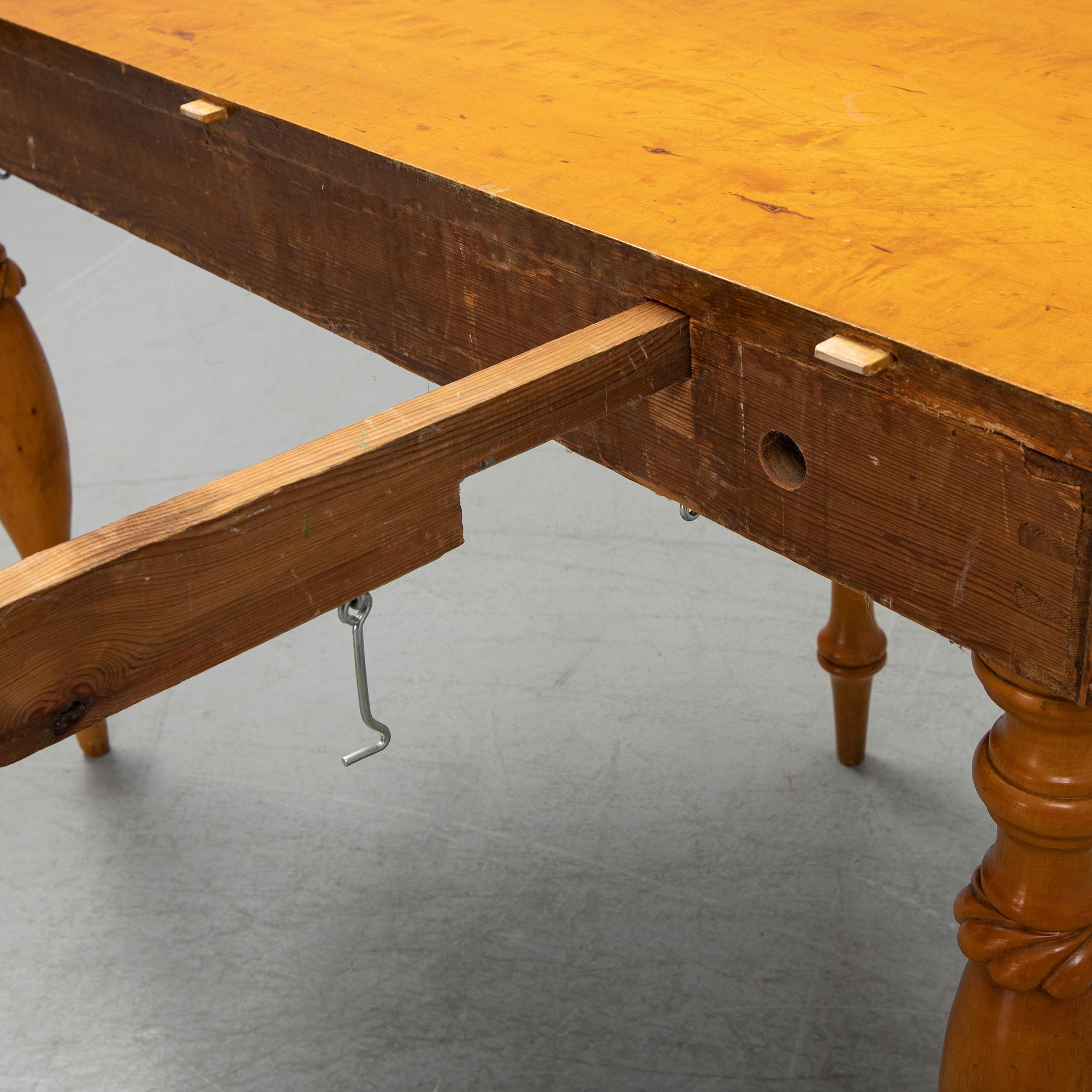 A mid 19th century birch dining table.