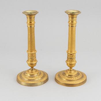 An early 19th Century pair of bronze empire candle sticks.