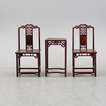 A pair of Chinese hardwood contemporary chairs and table.