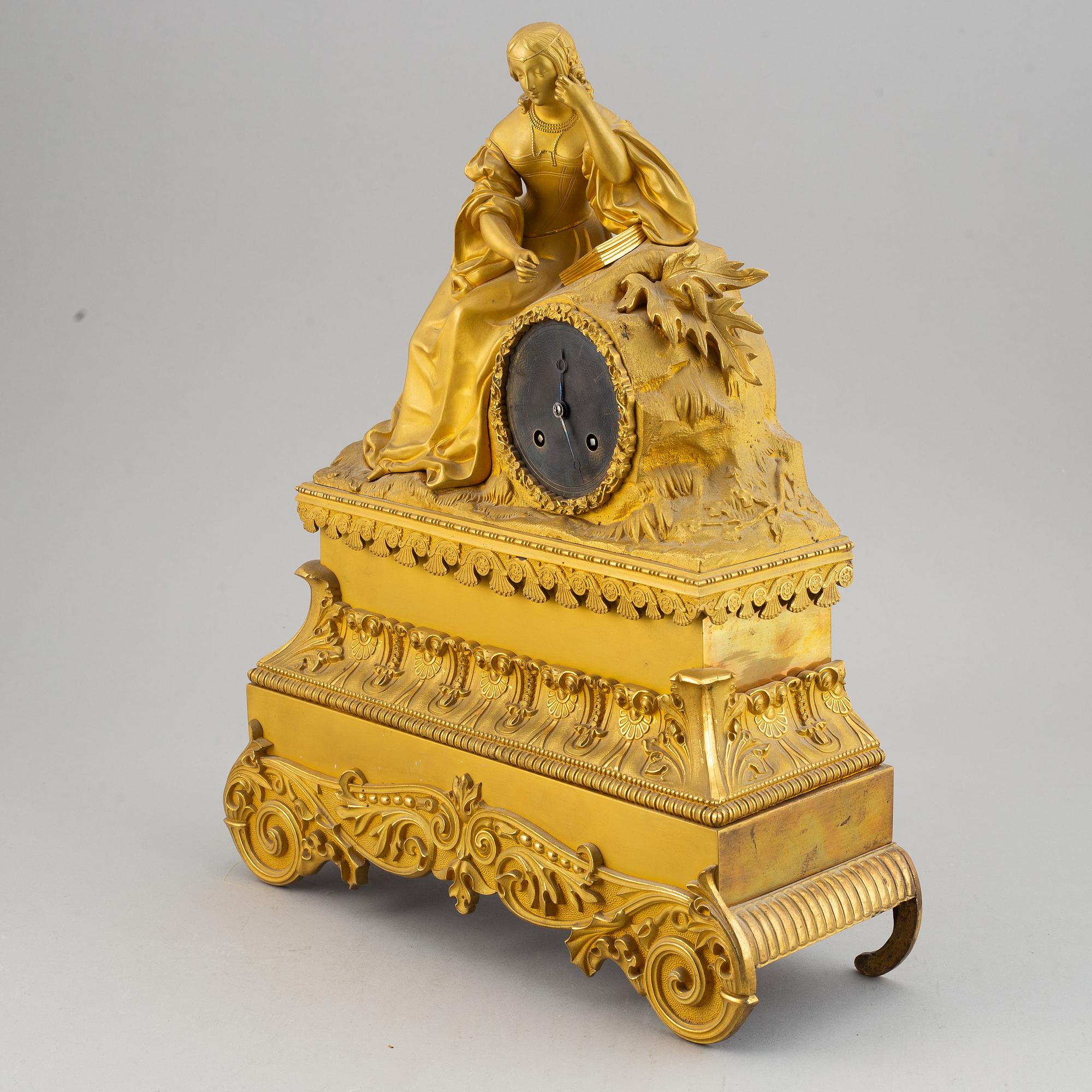 A French gilt bronze mantle clock, mid 19th century.