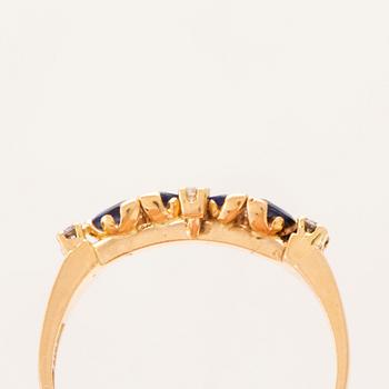 An 18K gold ring set with marquise cut, likely,  sapphires and round brilliant cut diamonds.
