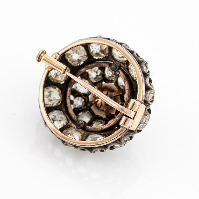 A silver and gold brooch, with cushion-cut diamonds and a pearl.