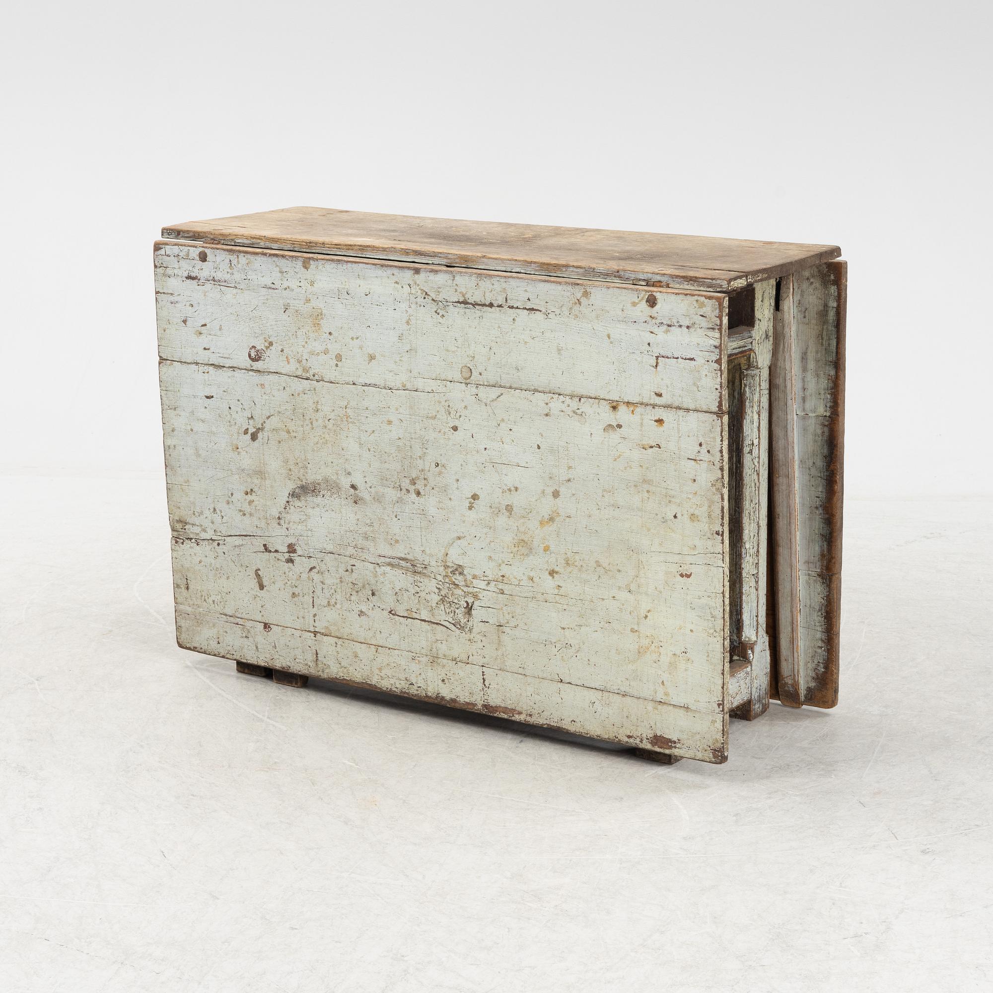 A 18th century gate-legged pine table.