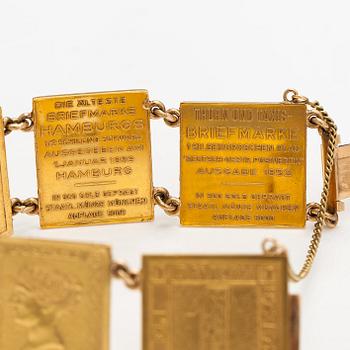 A bracelet with post stamps made of 900 gold..