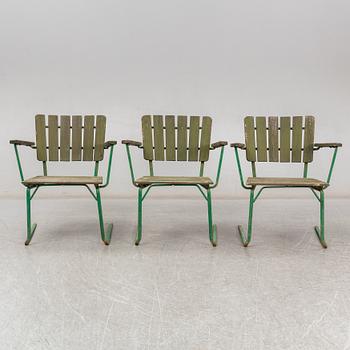 Three Arbrå stålmöbler and Grythyttan garden armchairs and a table, mid 20th century.