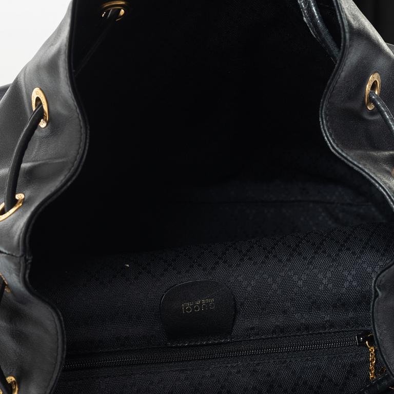 Gucci, A black leather backpack.