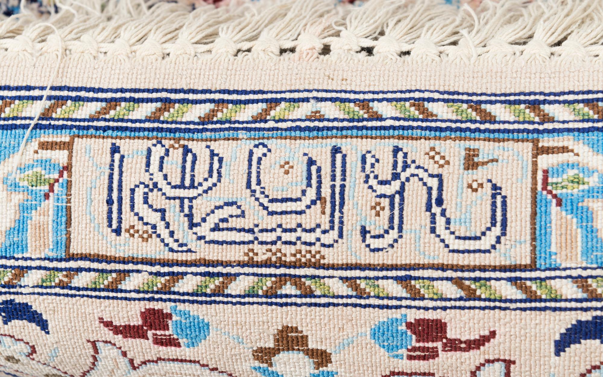 A oriental signed Nain silk carpet. Circa 267x163 cm.