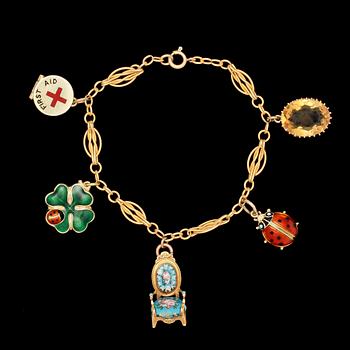 251. CHARMBRACELET, 14k gold and some charms 9 k. Weight 18,5 g.