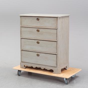 A painted chest of drawers from around the year 1900.