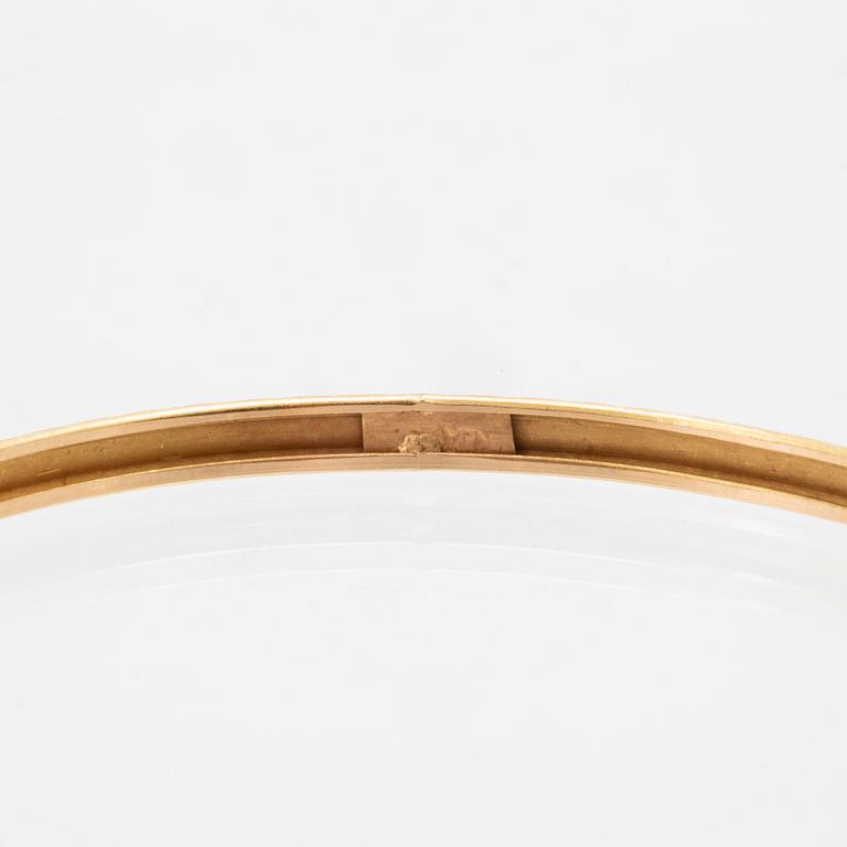 A pair of 18K gold bracelets for children.