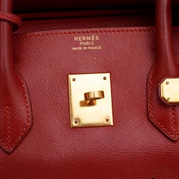 HERMÈS, a raspberry red leather "Birkin 35" bag.