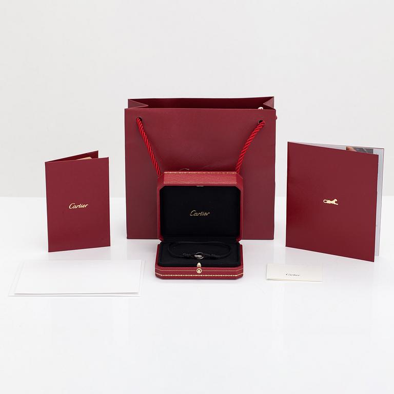 Cartier, A "Trinity" bracelet made of 18K white gold, ceramic and textile. Marked Cartier, JZY979.