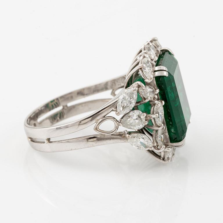 An 18K white gold ring set with a step-cut emerald.