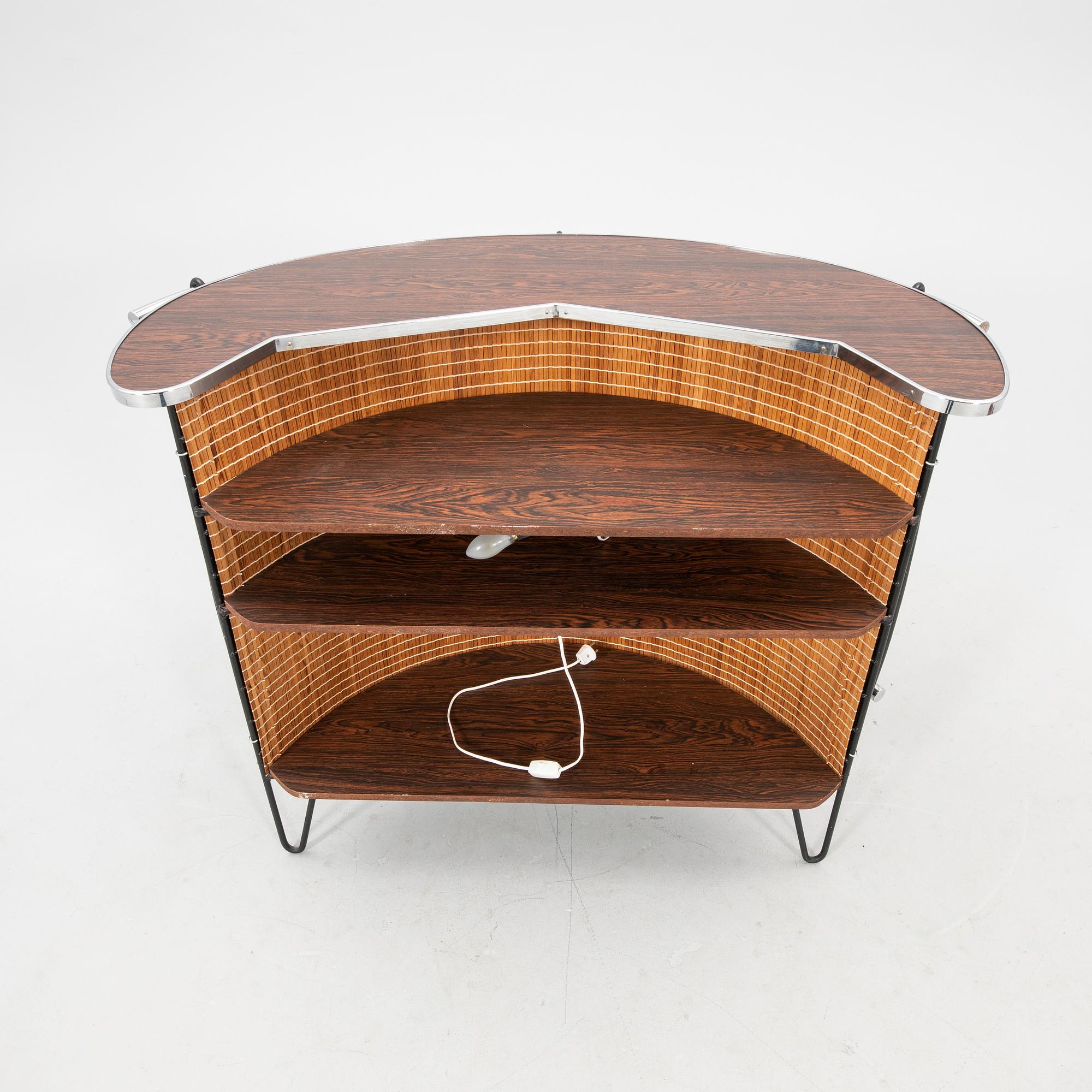 A 1970s bar and four stools.