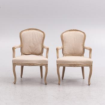 A painted pair of rococo armchairs, 19th century.