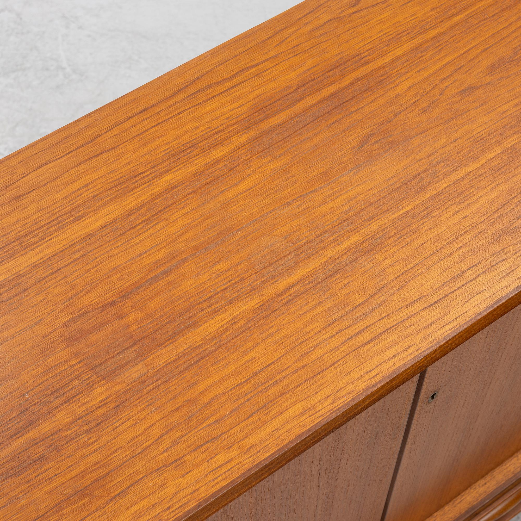 A mid20th century teak-veneered sideboard.