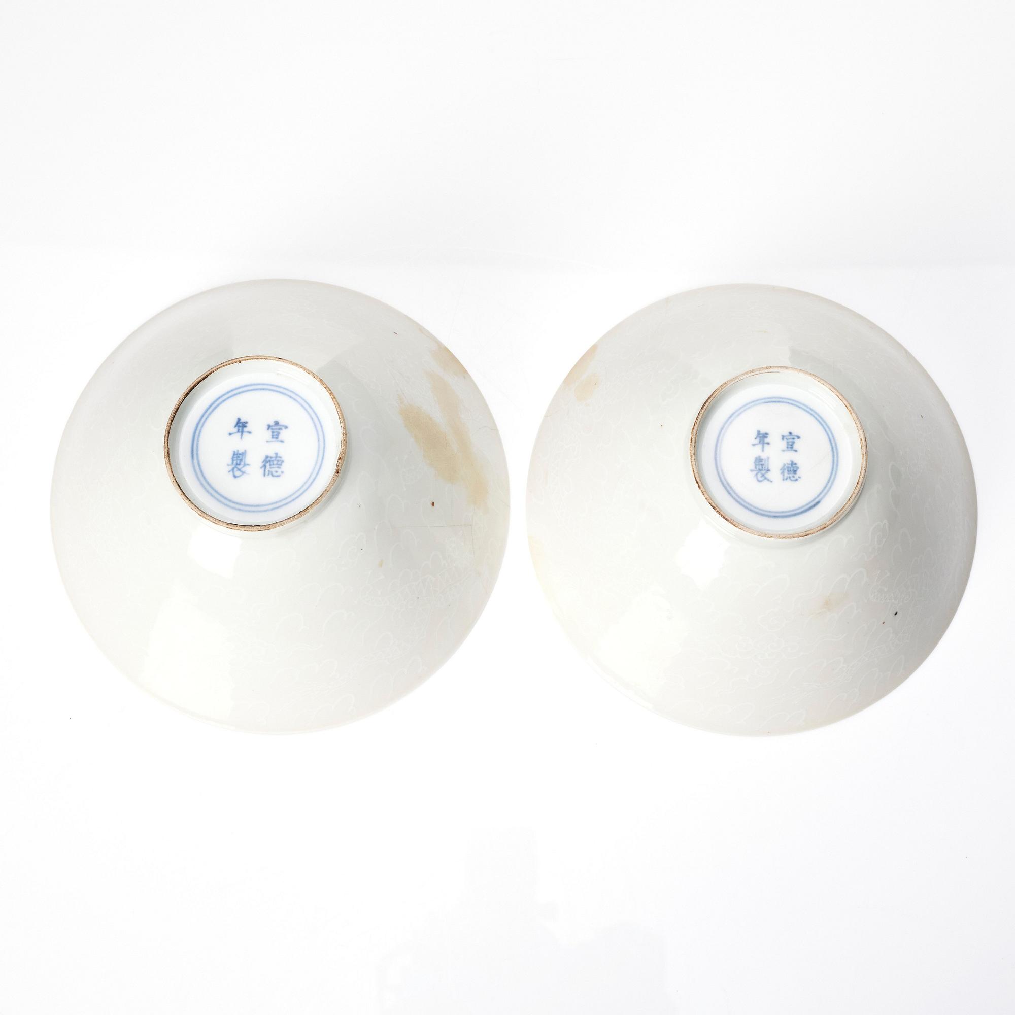 Two Chinese white glazed anhua decorated dragon bowls, Qing dynasty.