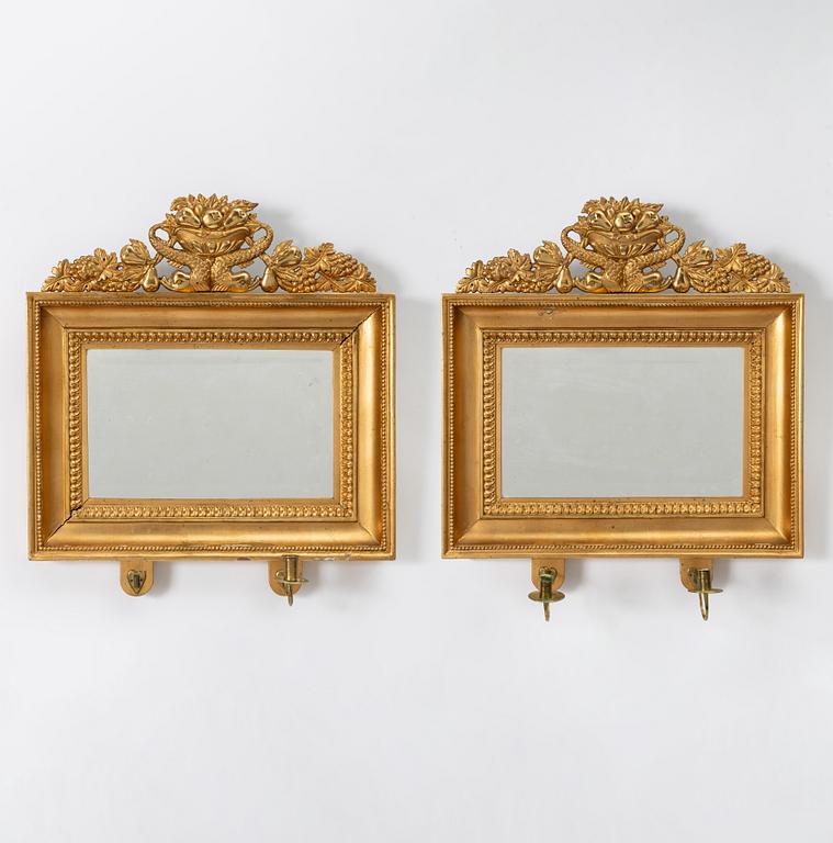 A pair of Late Empire gilded mirror sconces for two candles, Gothenburg, 1830s-40s.