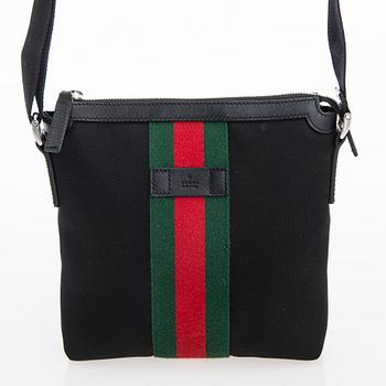 Gucci, a "Techno Canvas Web Messenger" bag.