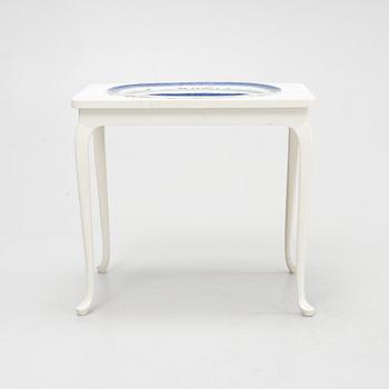 A blue and white porcelain dish, China, Qing dynasty, late 18th century, mounted in a table.