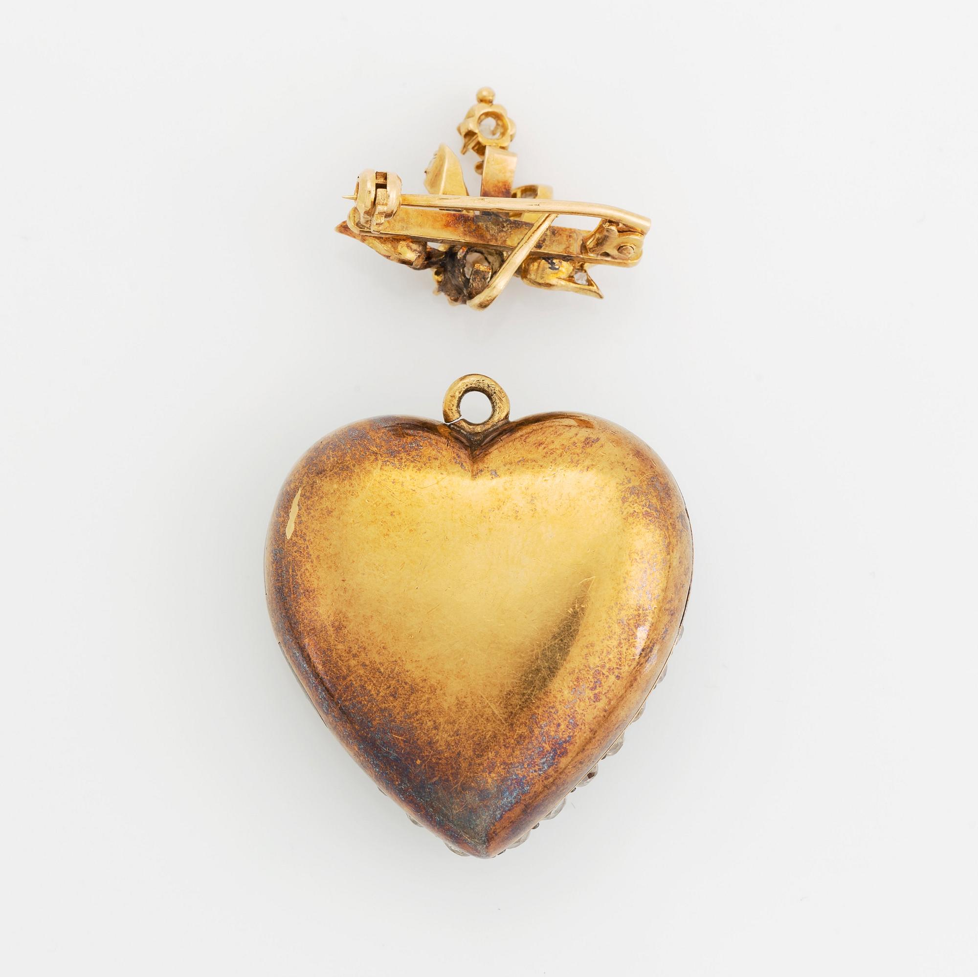 A pendant/locket in 18K gold set with old-cut diamonds, in the form of a heart.
