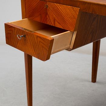 A mid 20th century elm veneered desk.