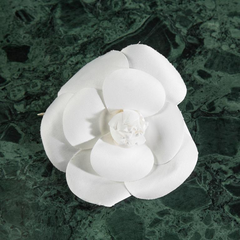 Camelia brooch by Chanel.