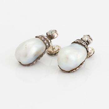 A pair of silver and pearl earrings set with old- and rose-cut diamonds.