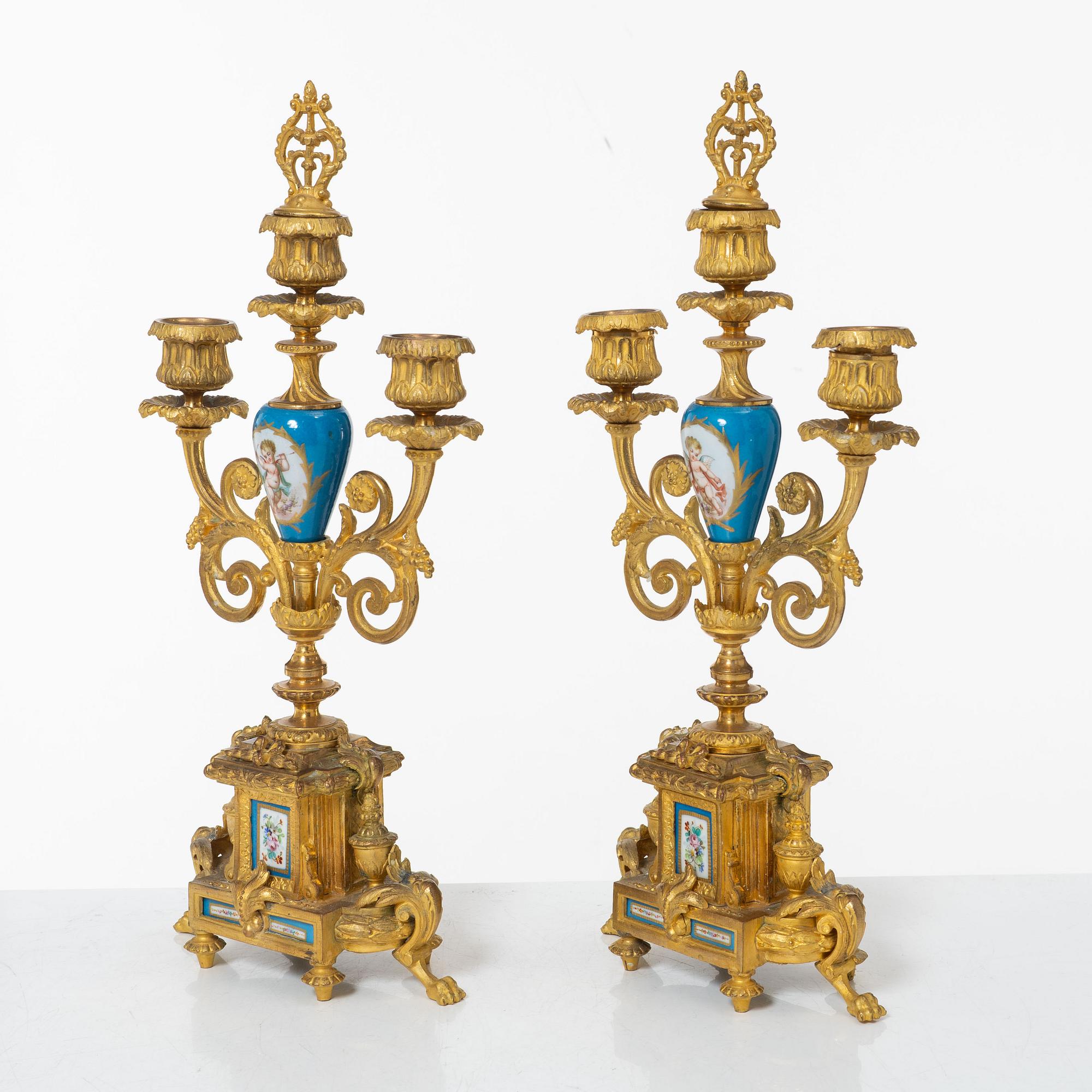 A French Louis XVI-style mantel clock and a pair of candelabra, late 19th Century.