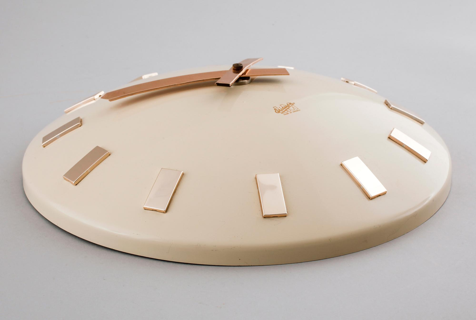 A 20th century wall clock by LM Ericsson.