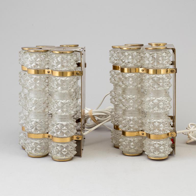 A pair of 1970's glass and brass wall lamps.