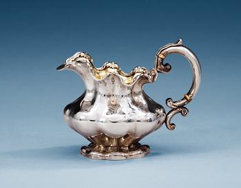 1163. A RUSSIAN PARCEL-GILT CREAM-JUG,Makers mark of Pavel Sazikov, Moscow 19th century.