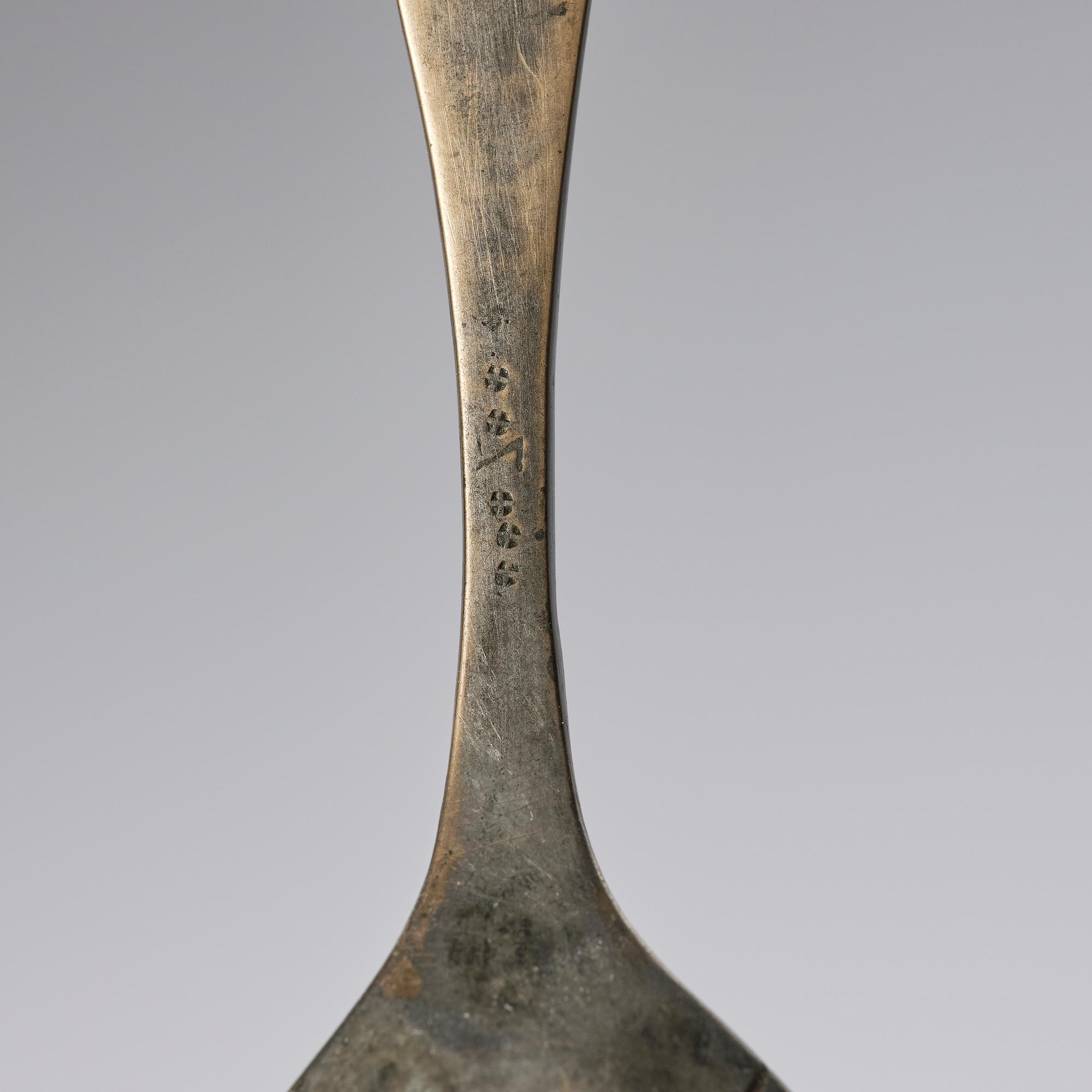 A set of three brass spoons, 18th century.