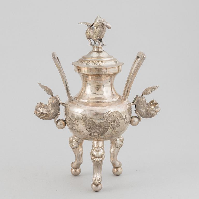 A Chinese metal incense burner in a wooden display case 20th century.