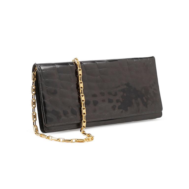 CÈLINE, a black croco clutch.