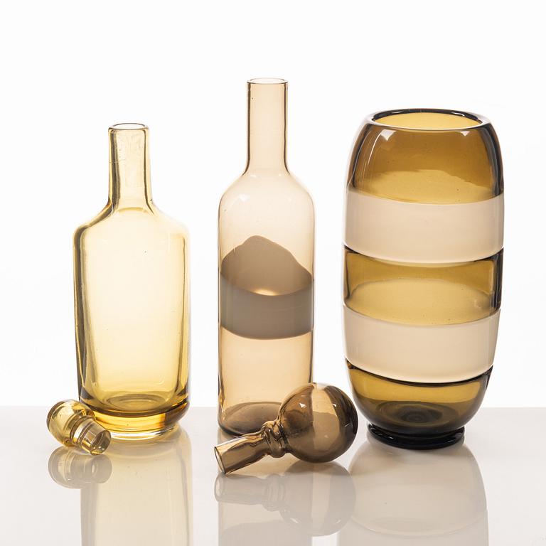 A glass vase and two bottles, including Archimede Seguso and Venini, Murano, Italy.