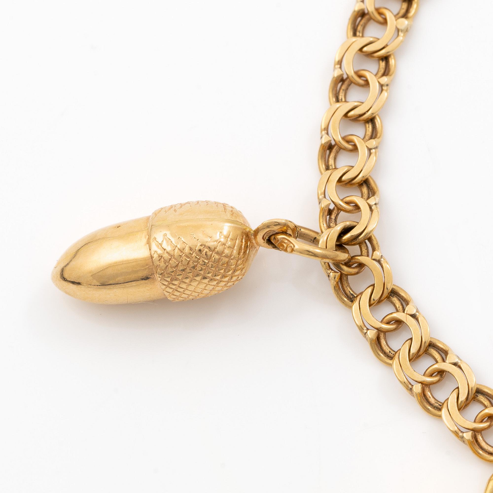 Bracelet 18K gold with five charms.