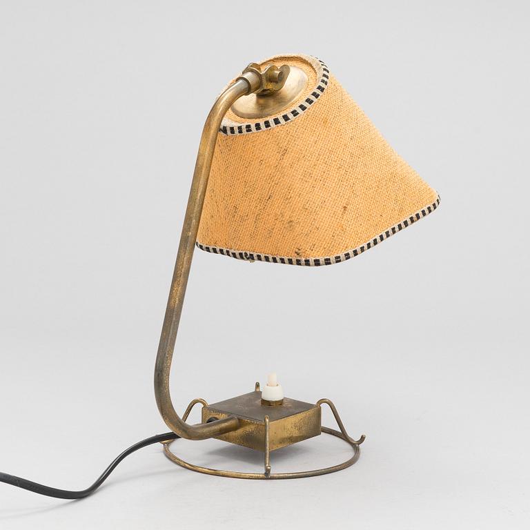 A mid-20th-century table lamp
/wall light for Idman.