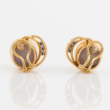 Gold with star sapphire and small diamond clip earrings, A. Tillander.