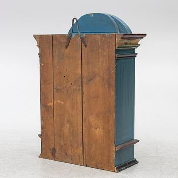 A 19th century folk art hanging cabinet.