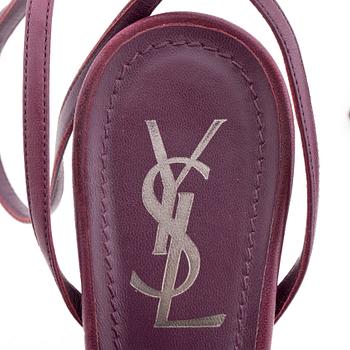 YVES SAINT LAURENT, a pair of dark leather sandals.