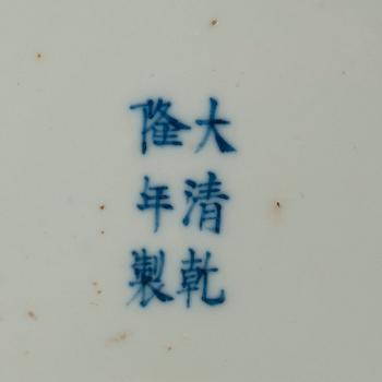 A yellow ground famille rose dish, Late Qing dynasty, with Qianlong six character mark.