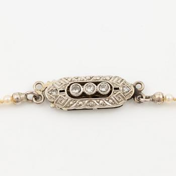 Pearl necklace, graduated pearls, clasp in 18K white gold with small diamonds.