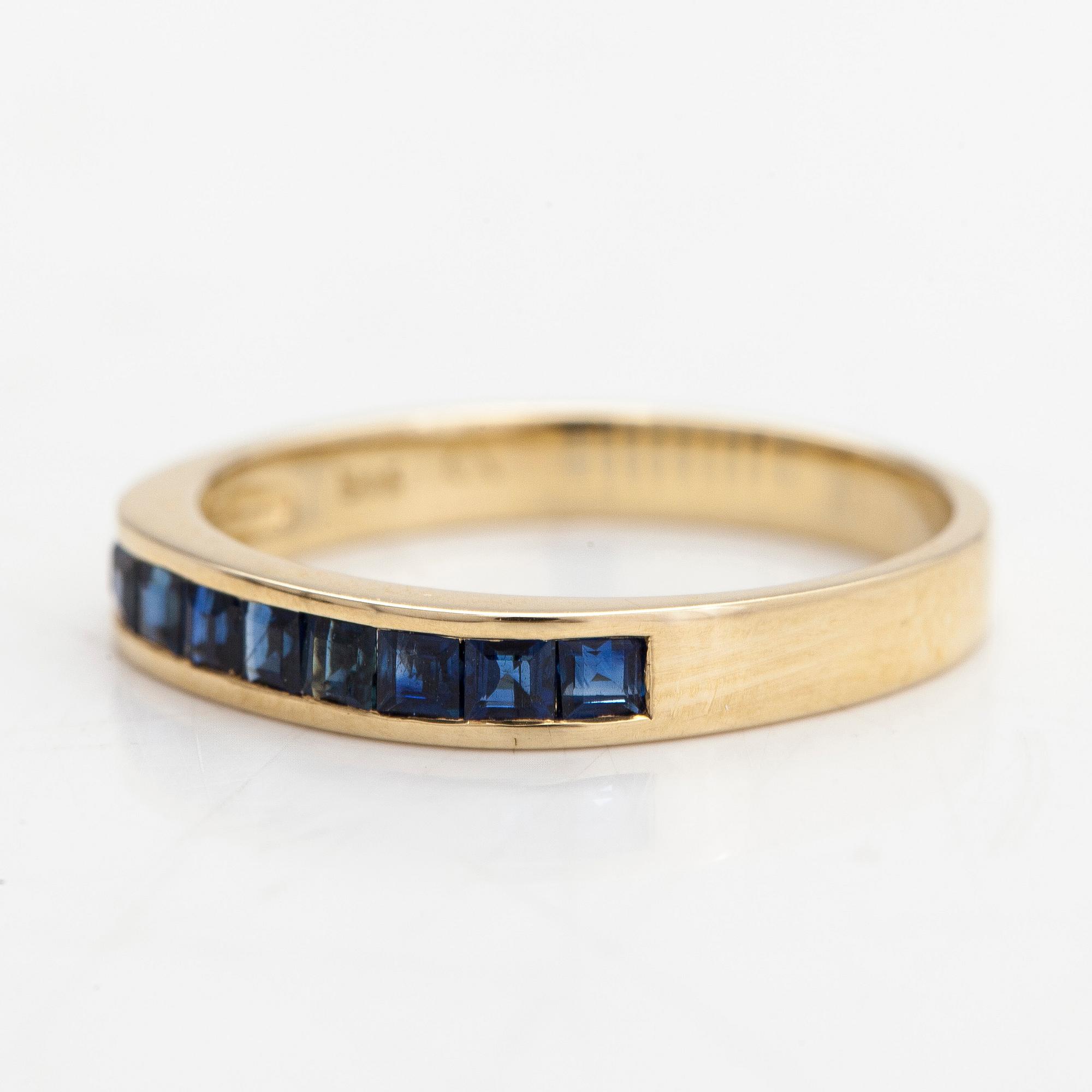 A half-eternity 14K gold ring with sapphires.