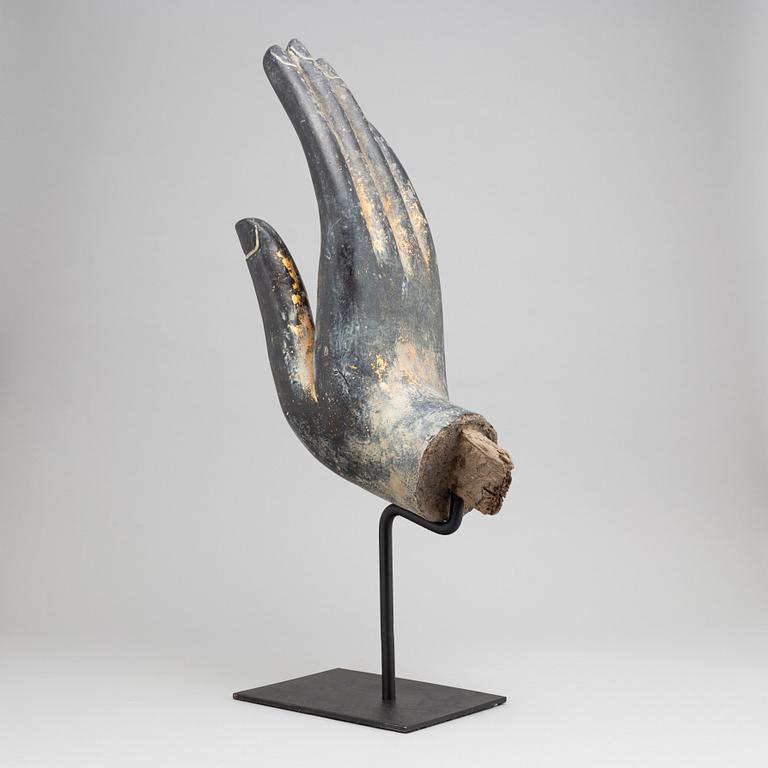 A wooden sculpture of Buddhas hand, Thailand, 20th century.