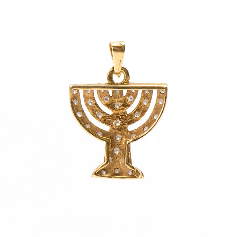 An 18K gold menorah pendant with diamonds.