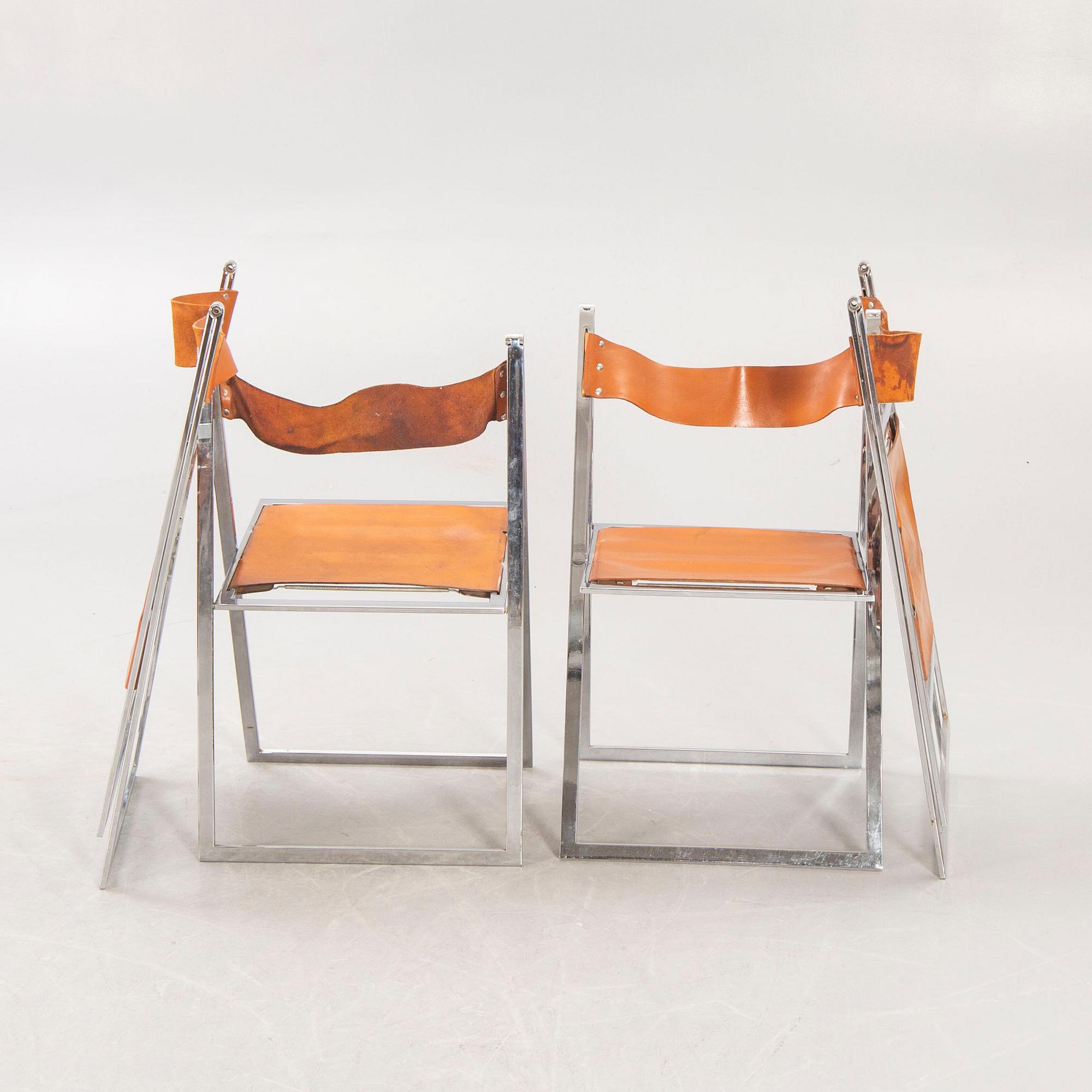 A set f four Fontoni & Geraci leather and chrome folding chairs