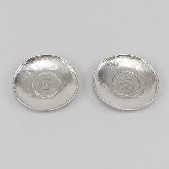 A pair of Chinese silver dishes, with coins, 20th Century.