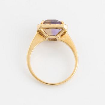 An 18K gold and ametrine ring set with round brilliant-cut diamonds.