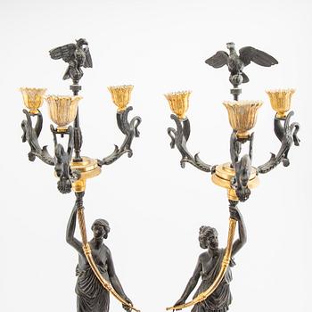 A pair (nearly) of Empire style candelabras later part of the 19th century.